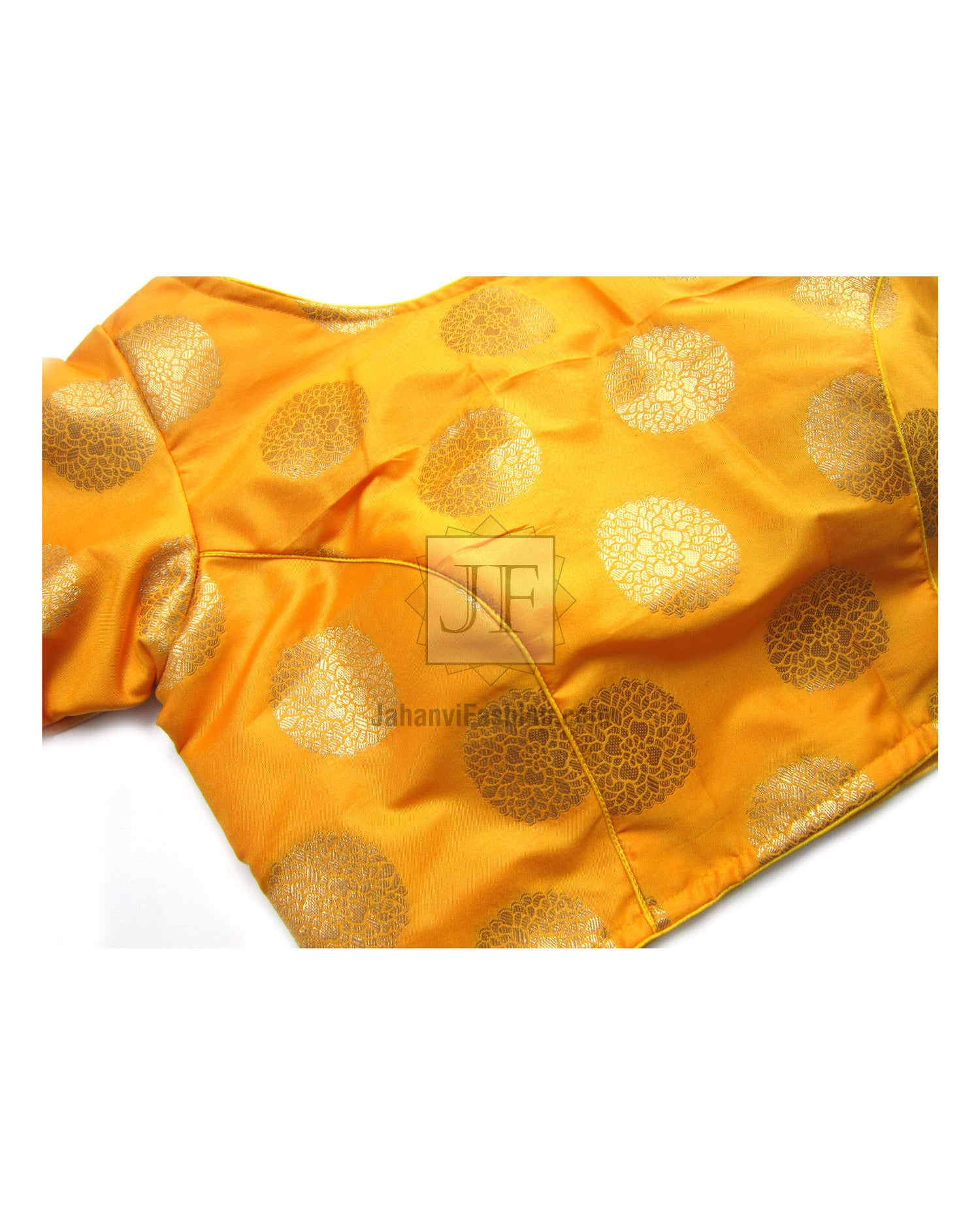 Close-up orange brocade silk saree blouse panel with boat neckline and gold circular motifs