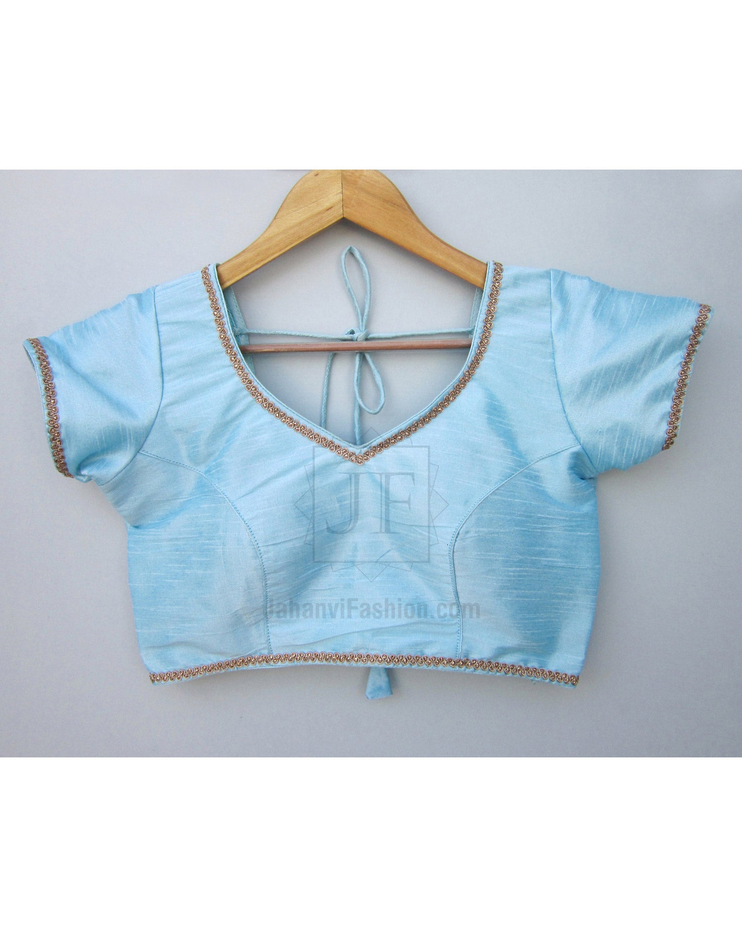 Light blue short-sleeve saree blouse with gold lace trim and tie-back neckline