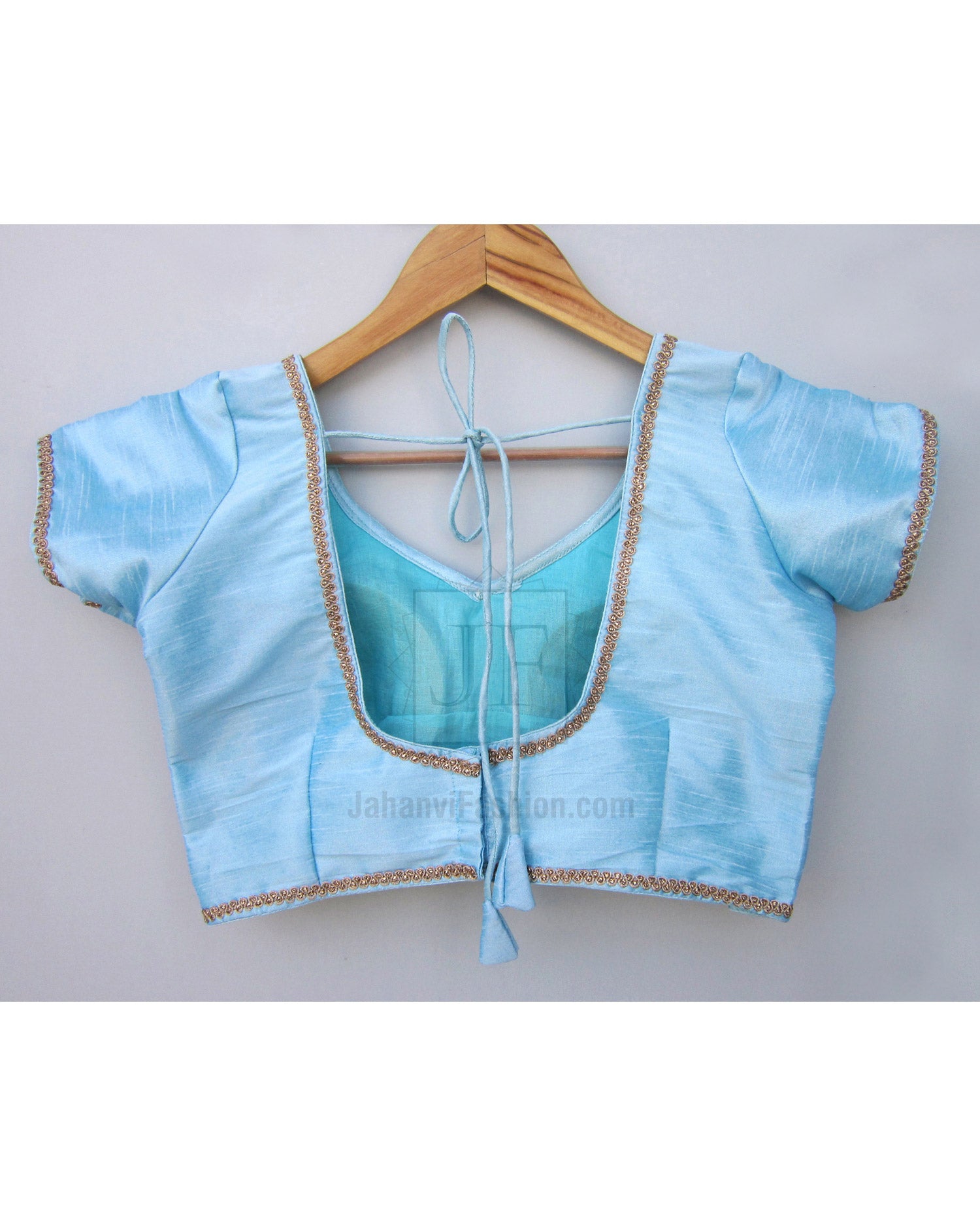 Light blue saree blouse with gold lace edging, short sleeves, open tie-back design