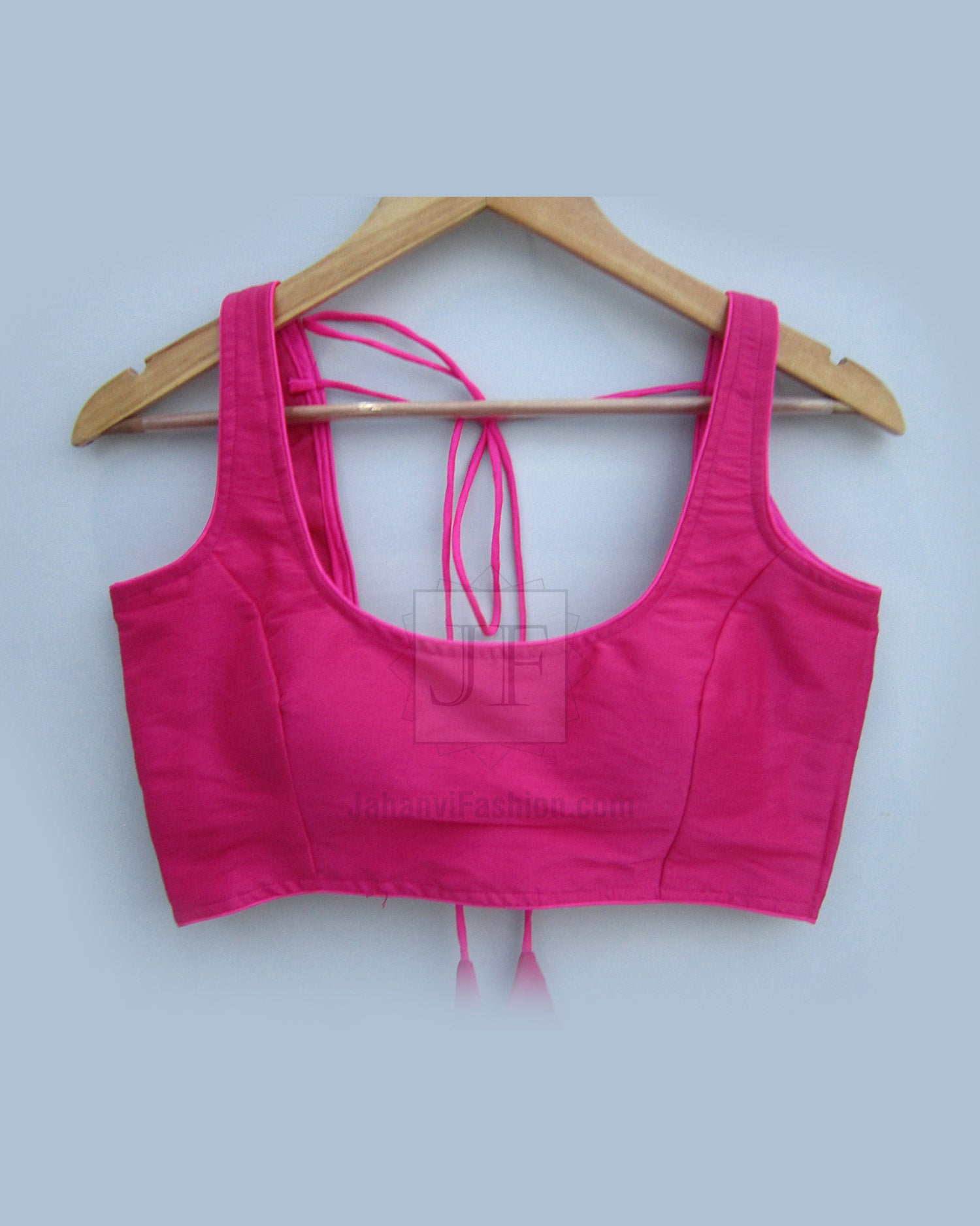 Fuchsia sleeveless saree blouse with semi-halter neckline, open back tied with ribbons