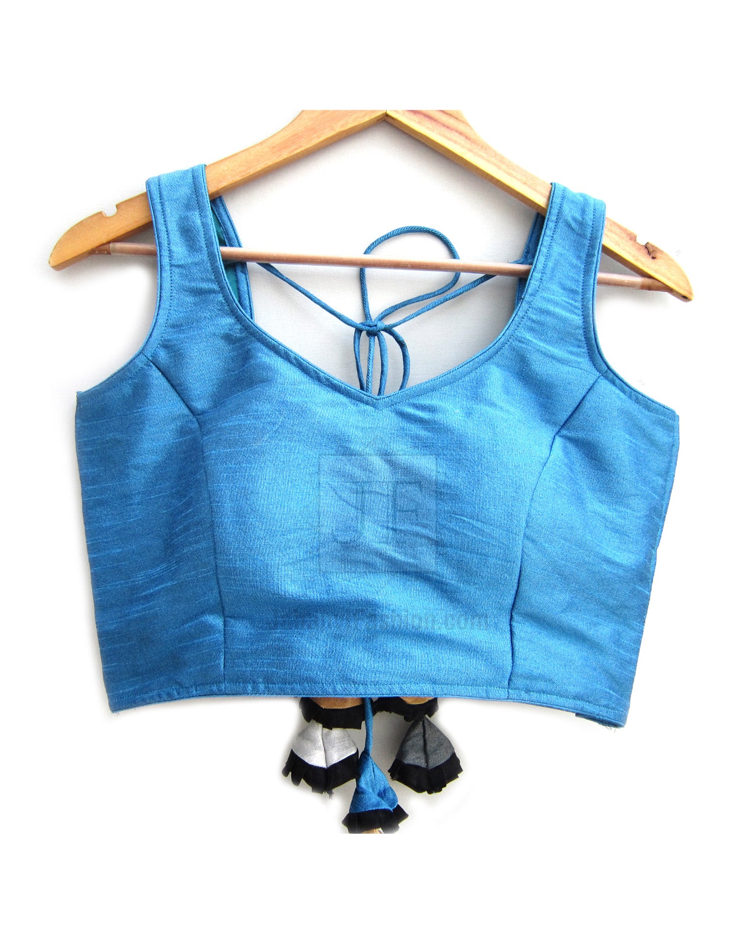 Blue sleeveless saree blouse with open back and tie lacing, tassel trim