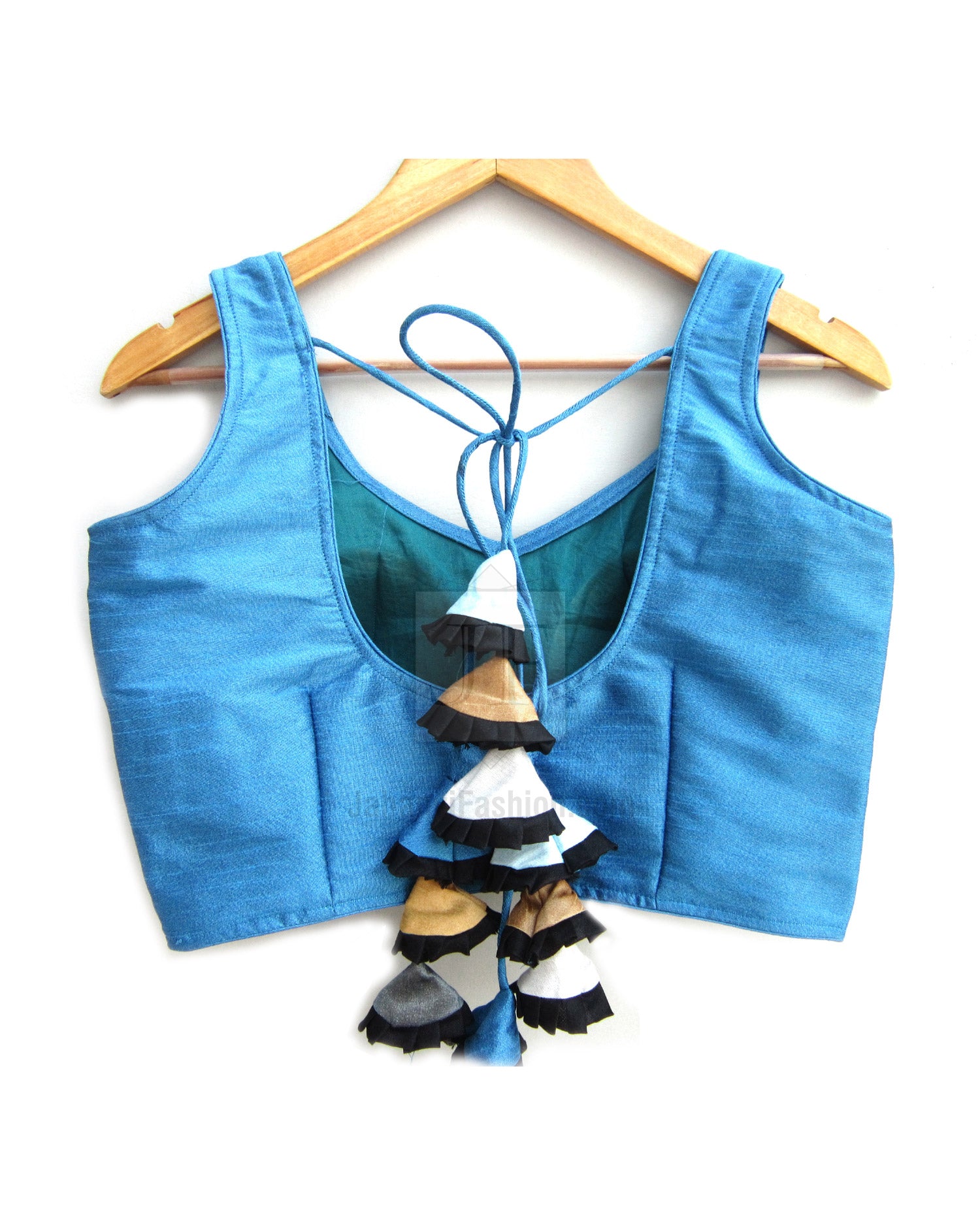 Blue sleeveless blouse with open back, tie lacing, and layered tassel embellishment