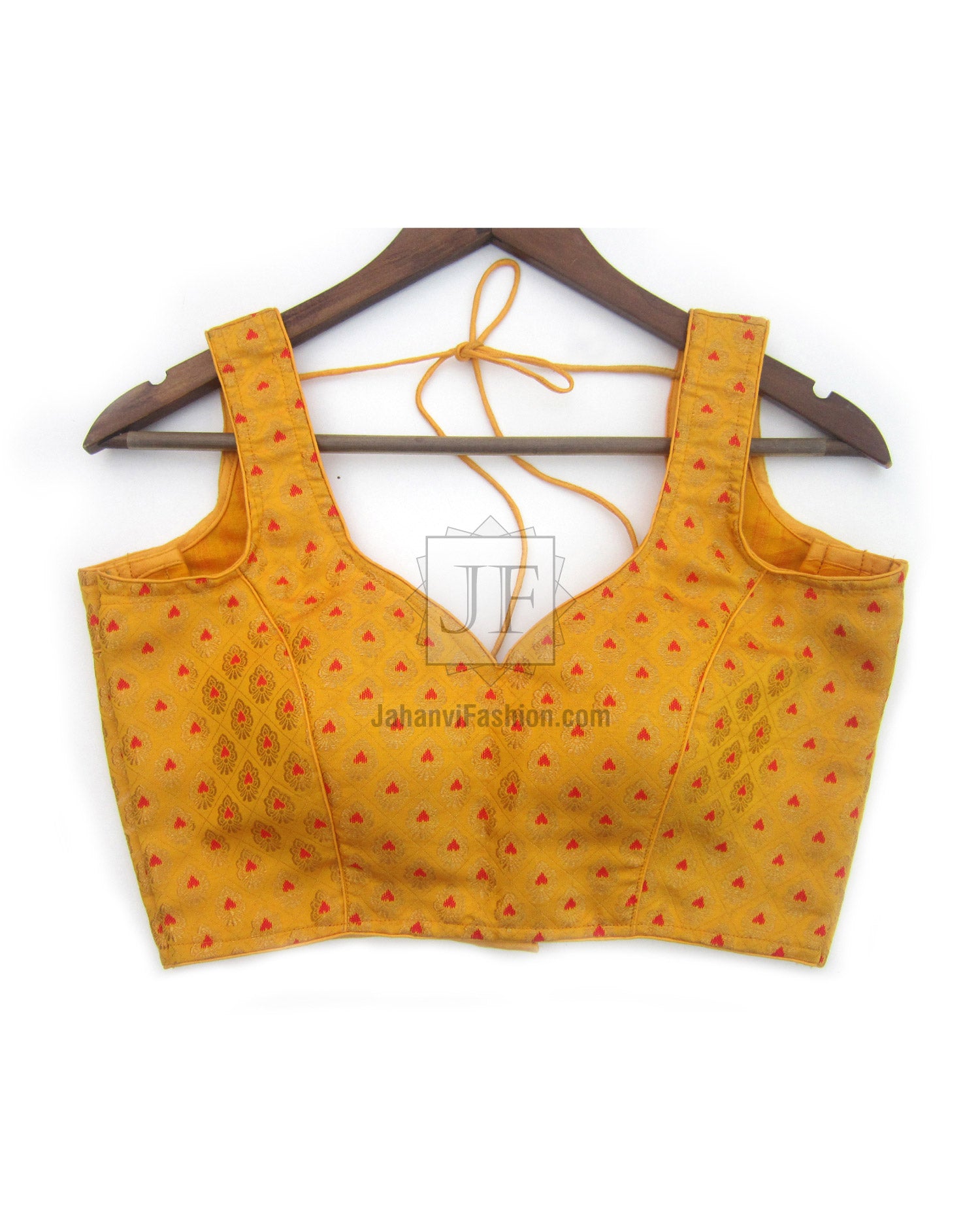 Sleeveless golden saree blouse with red motifs, square neckline, tie-back straps