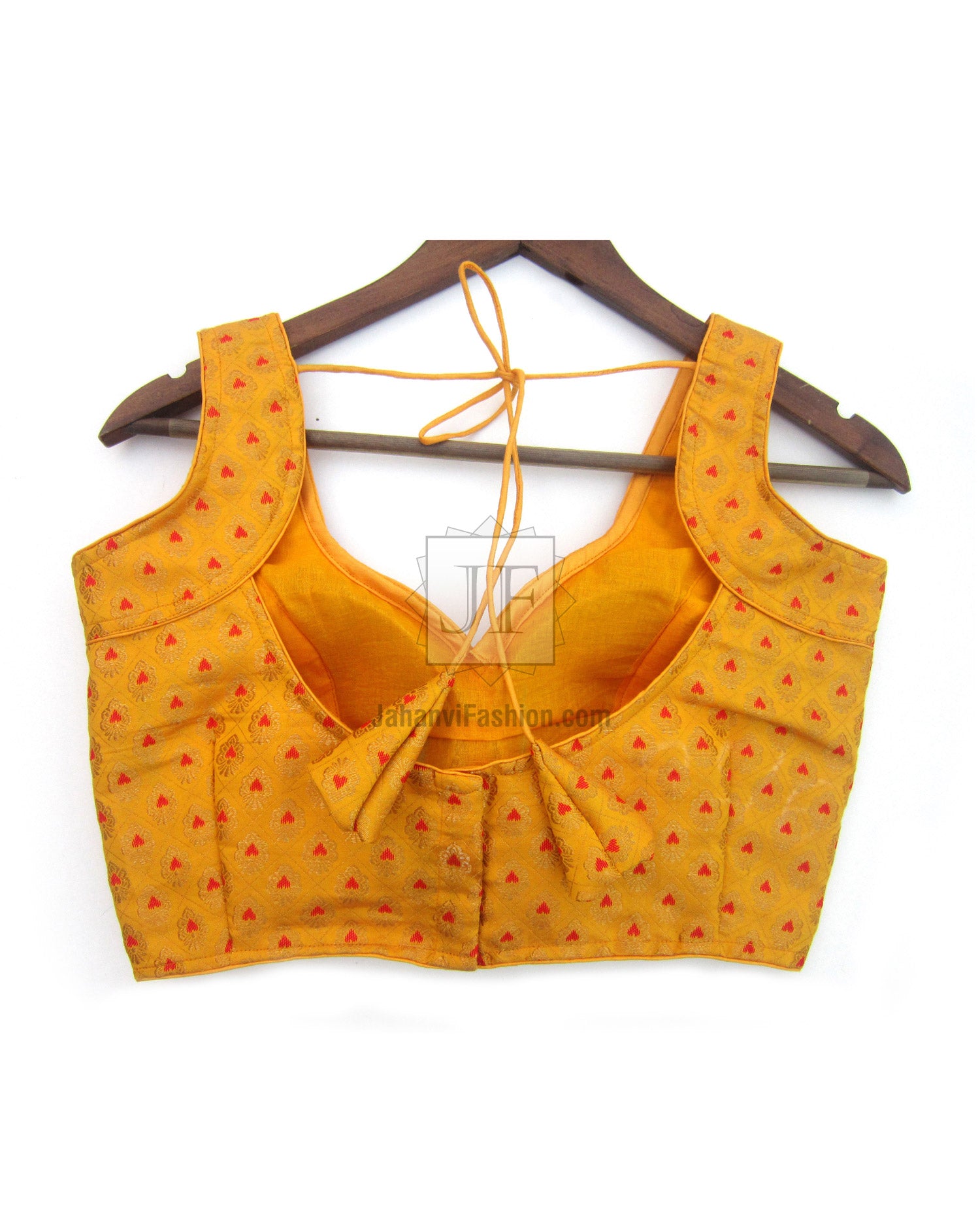Sleeveless golden saree blouse with red motifs, deep V neckline and adjustable tie-back