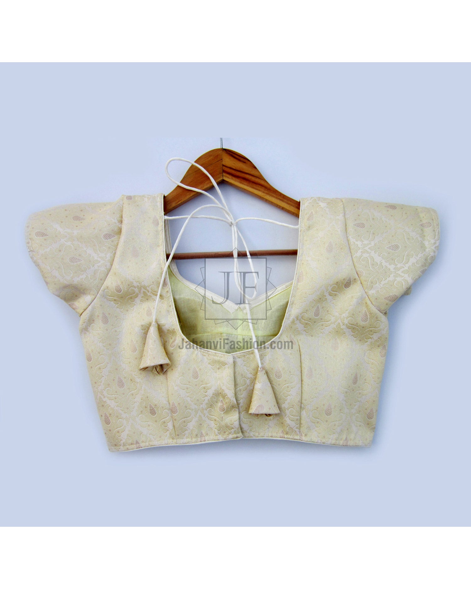 Cream-gold short-sleeve saree blouse with embroidered leaf pattern and square neckline.