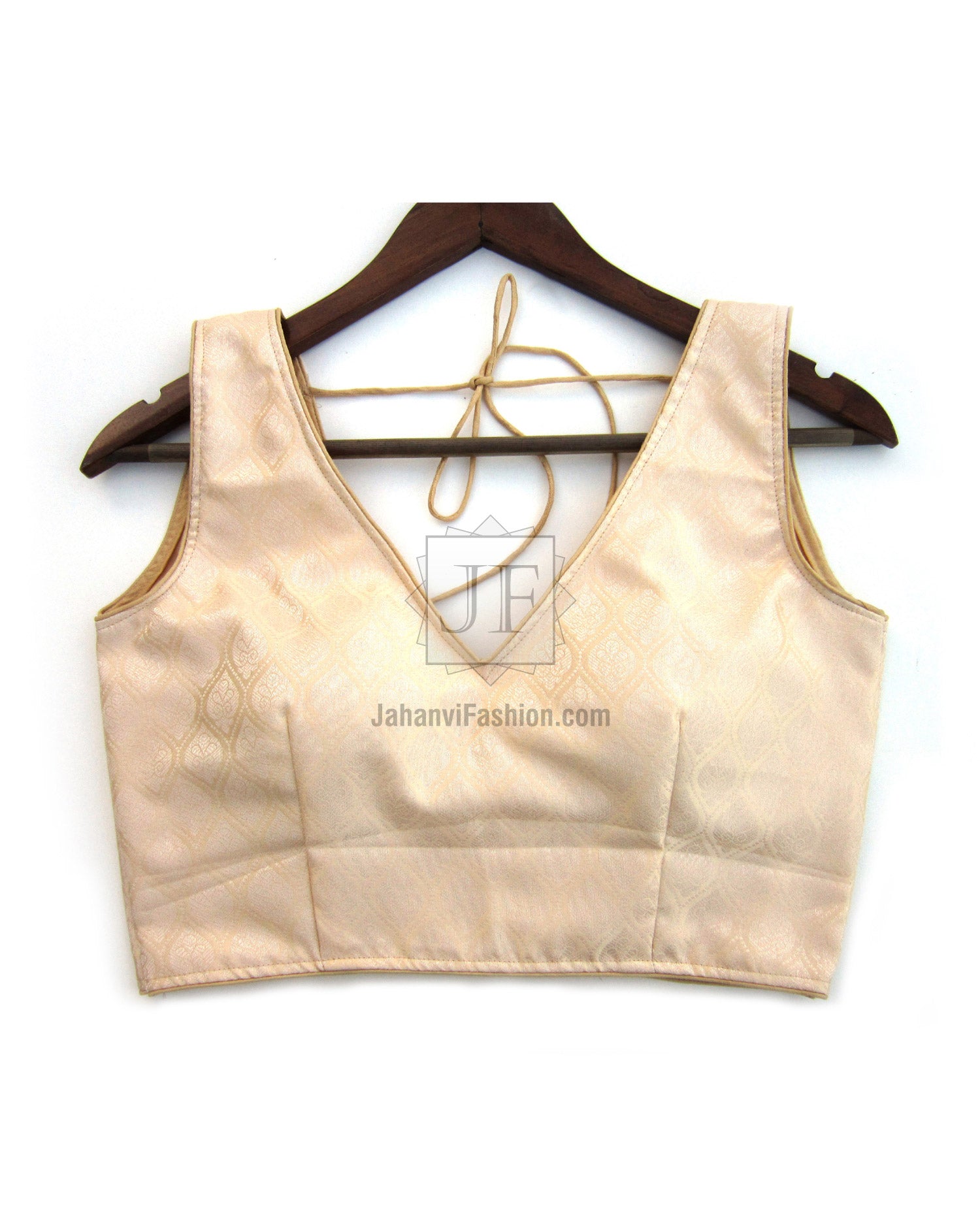 V-neck sleeveless saree blouse, light gold, front with fitted waist seam.