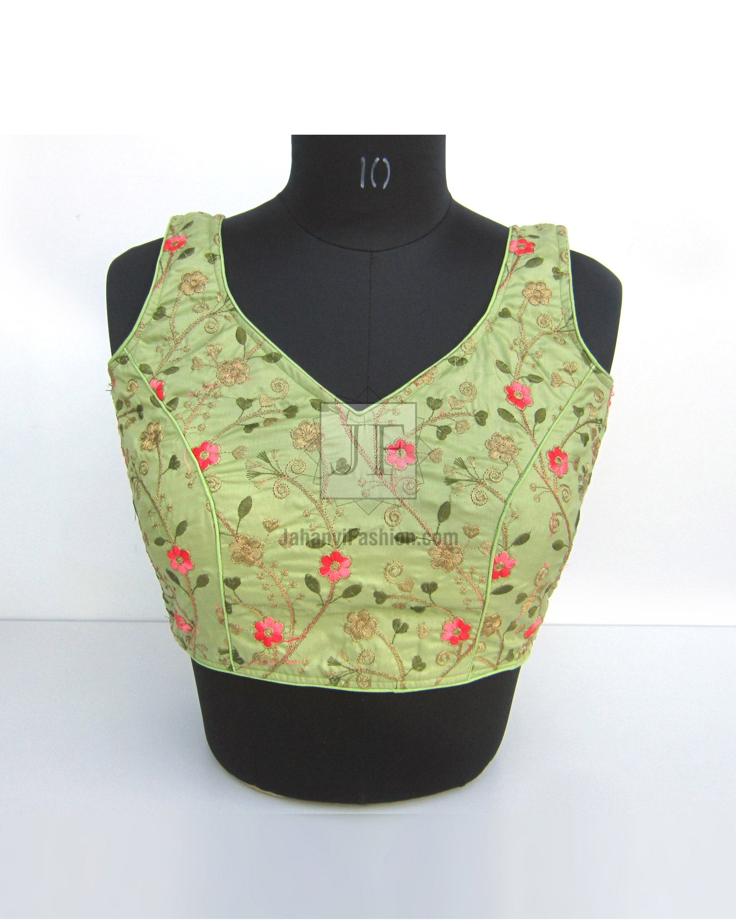 Light green embroidered V-neck saree blouse with cap sleeves and floral motifs