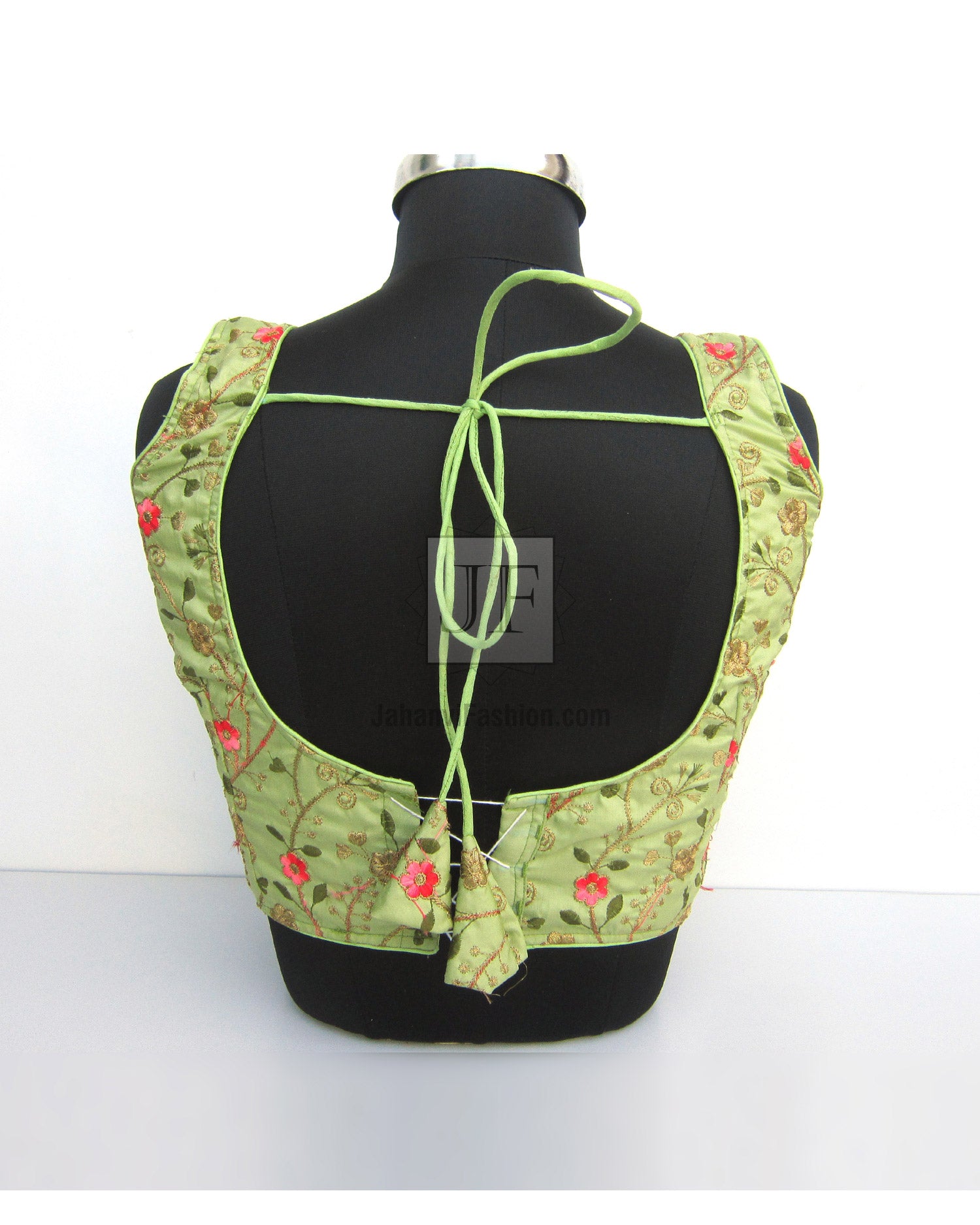 Light green embroidered saree blouse back with neck tie strings and floral trim