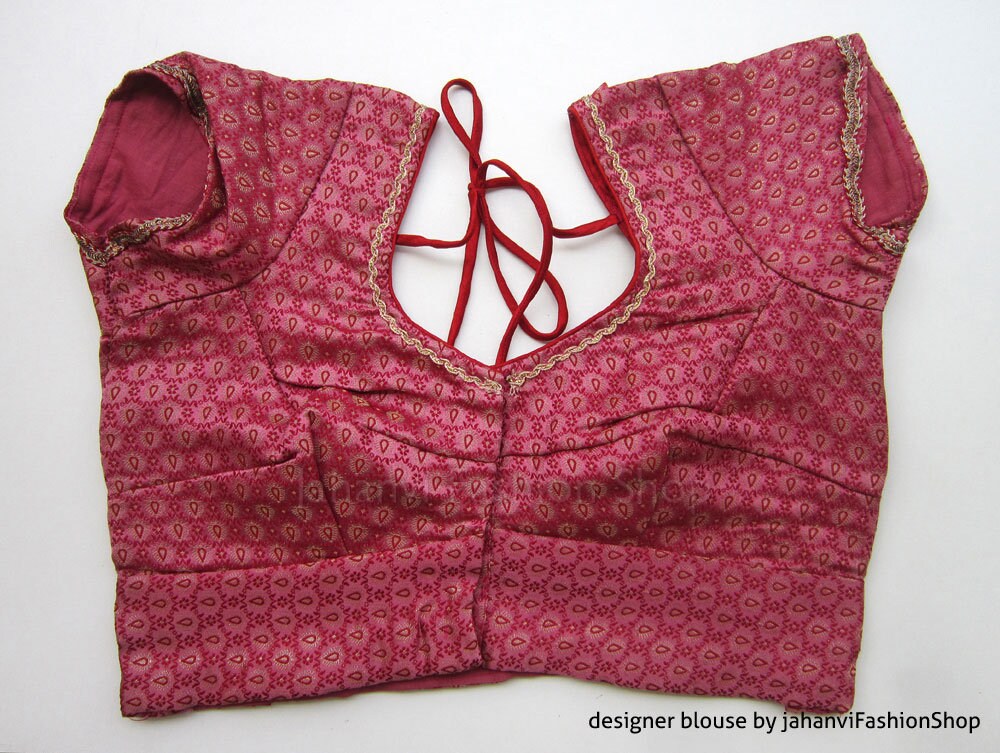Magenta brocade saree blouse with allover leaf print, puff sleeves, back crisscross ties