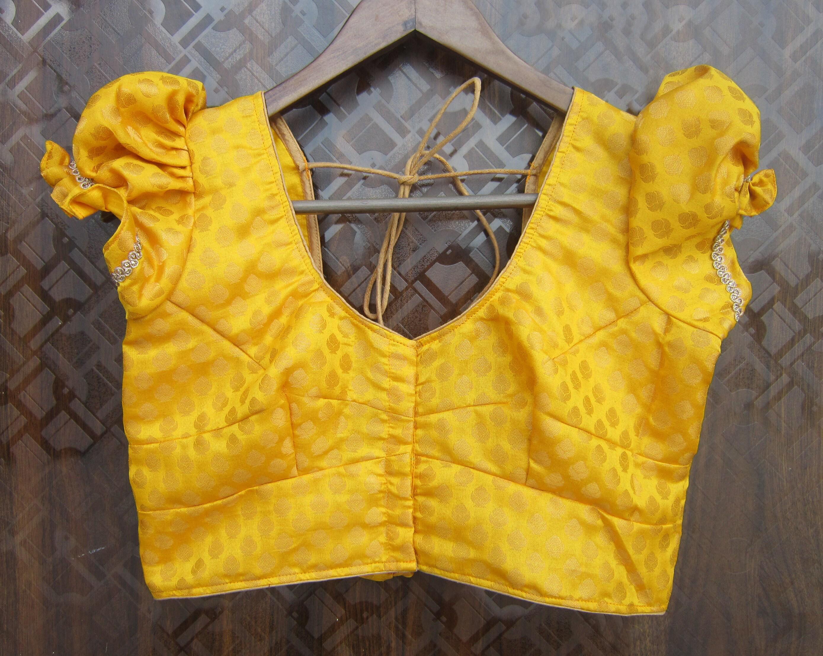 Yellow patterned chanderi silk saree blouse with puff sleeves and V-neck front