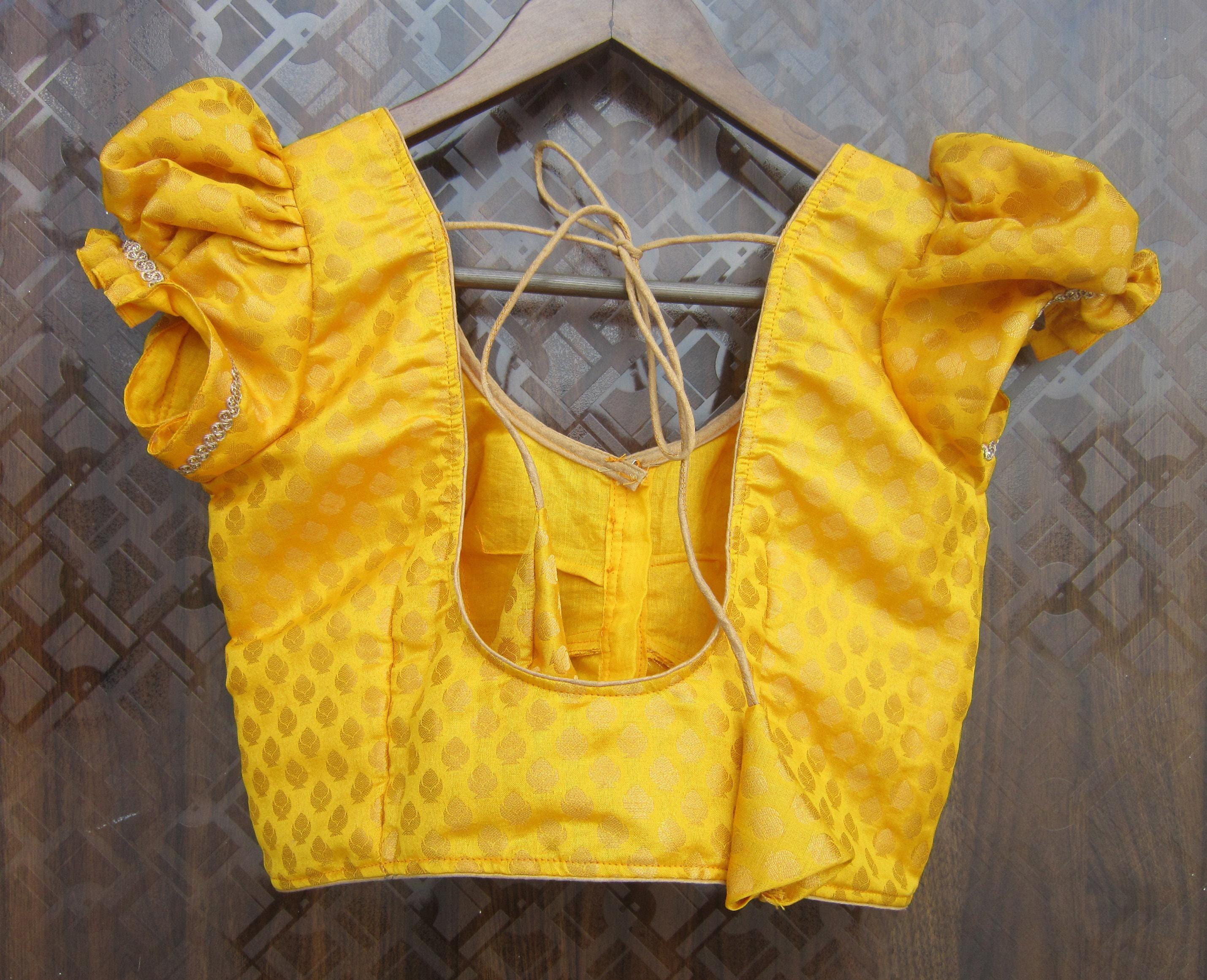 Yellow patterned silk saree blouse with puff sleeves and V-neck front hook closure