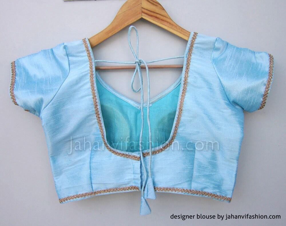 Light blue saree blouse back with gold lace trim and center bow tie, short sleeves