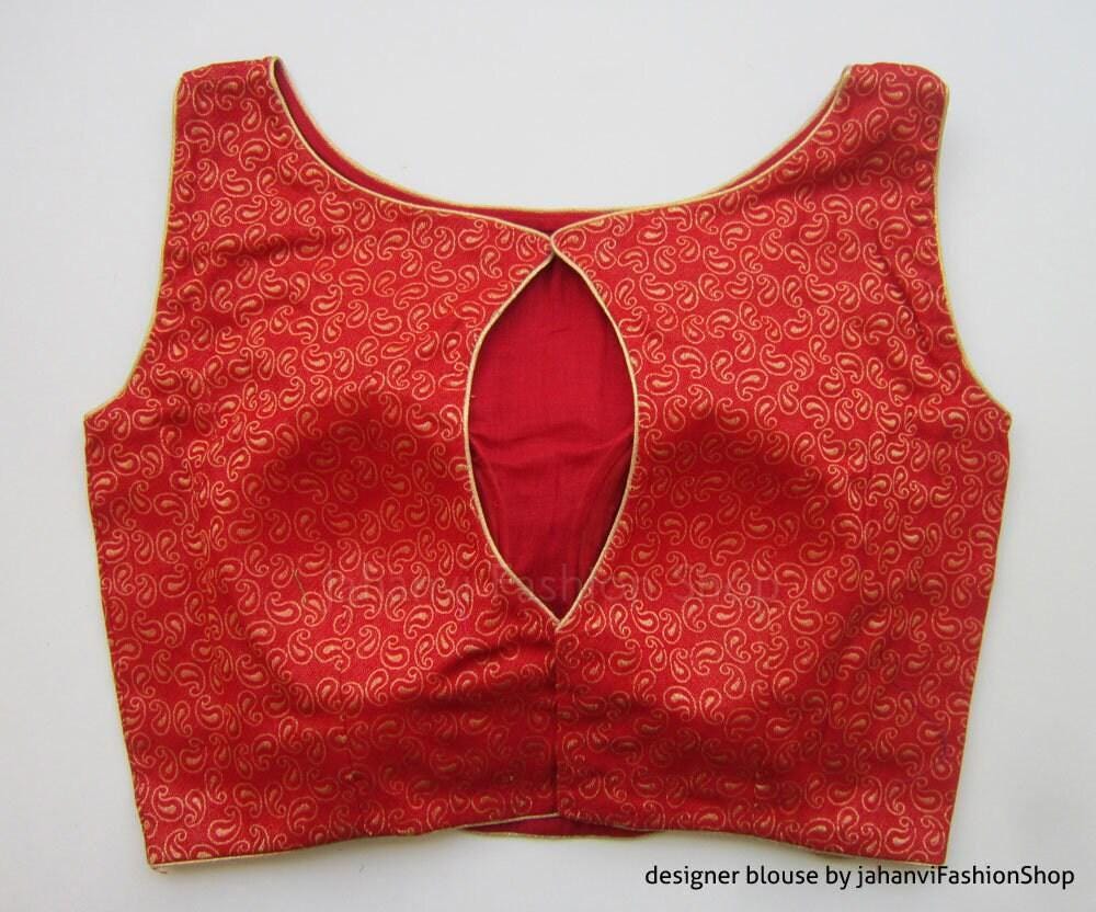 Red sleeveless blouse with boat neck and oval keyhole cutout, brocade swirl pattern