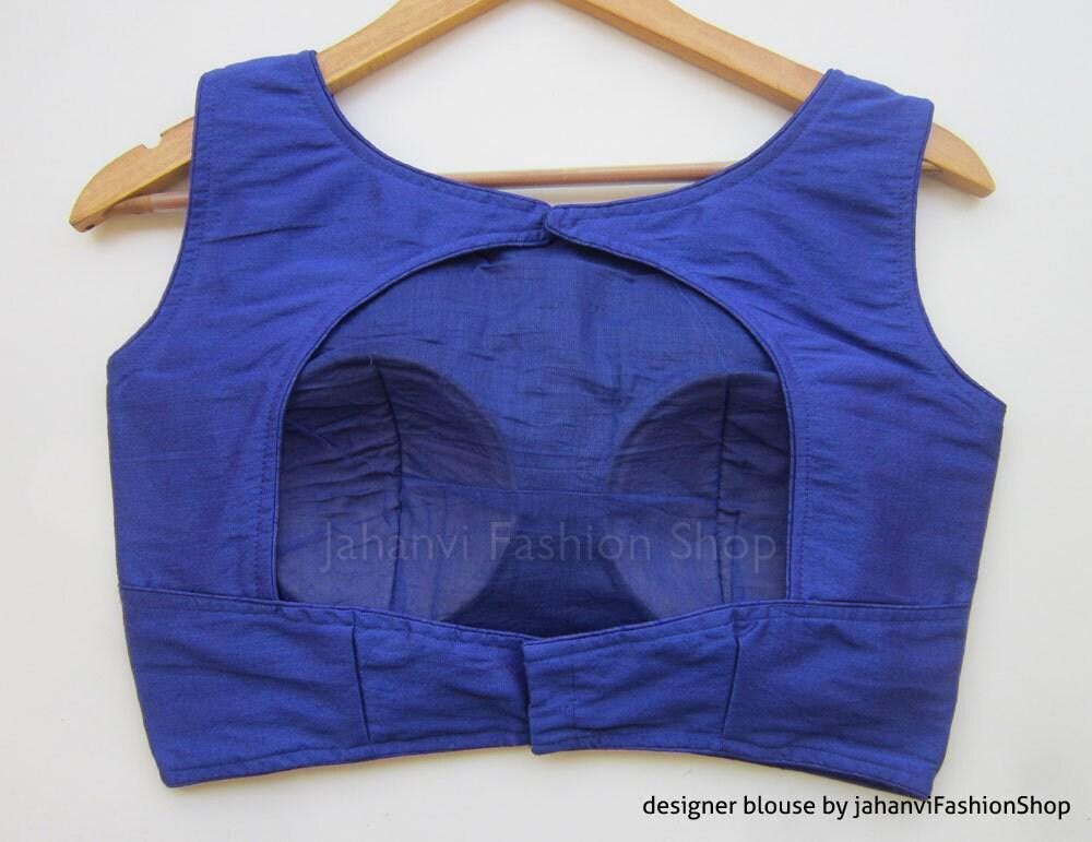 Royal blue sleeveless saree blouse back with curved neckline and stitched panels