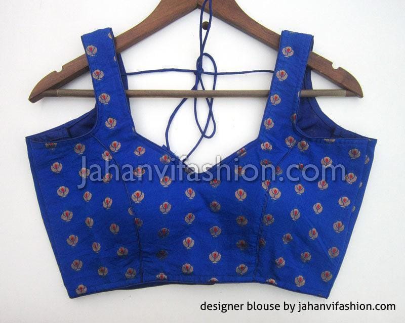 Blue sleeveless saree blouse with wide armholes, V-shaped back cutout, and tiny floral print