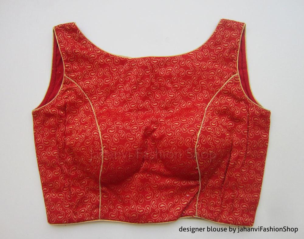 Red sleeveless blouse with boat neck, allover brocade swirl pattern