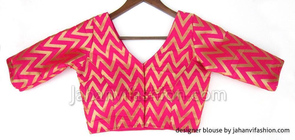 Magenta V-neck brocade saree blouse with zigzag pattern and three-quarter sleeves
