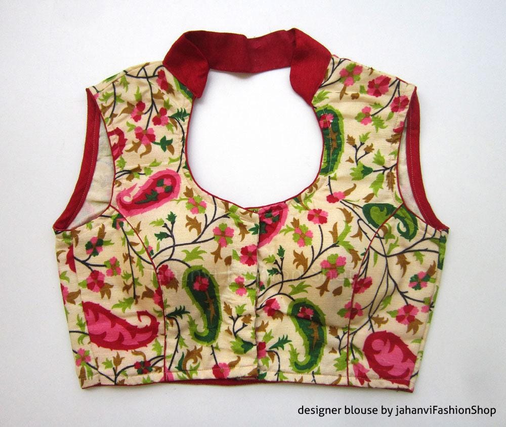 Printed sleeveless saree blouse with red high neck trim, floral peacock motifs front