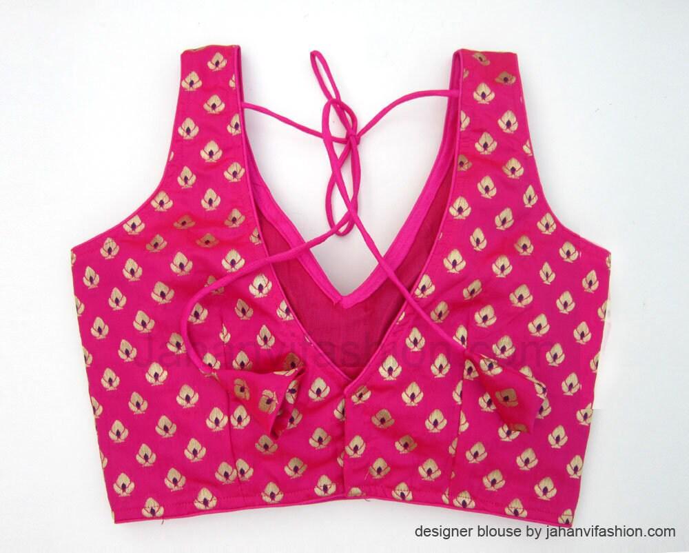 Magenta sleeveless V-neck blouse with gold pattern and center lace-up tie