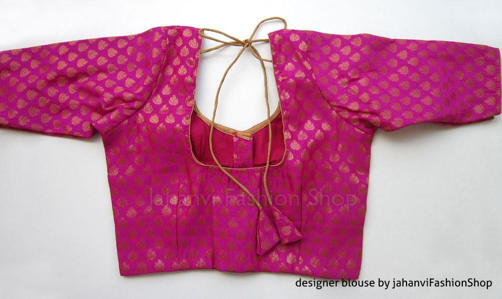 Magenta brocade saree blouse with gold motifs, wide sleeves, back tie with keyhole neck