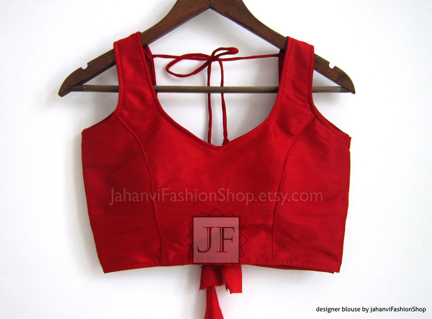Red sleeveless saree blouse with round neck and tie-back detail, princess-cut sleeves