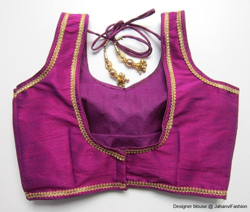 Designer saree blouse with golden edging, sleeveless violet with curved V-neck trim
