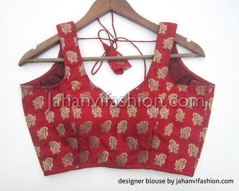 Maroon brocade sleeveless saree blouse with gold motifs and back hook closure