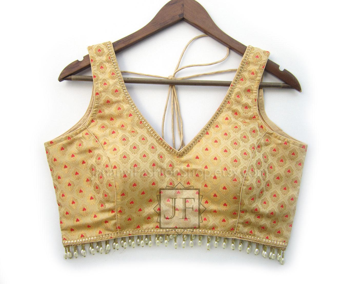 Cream-gold brocade blouse, V-neck sleeveless with embroidered trim and tassel hem