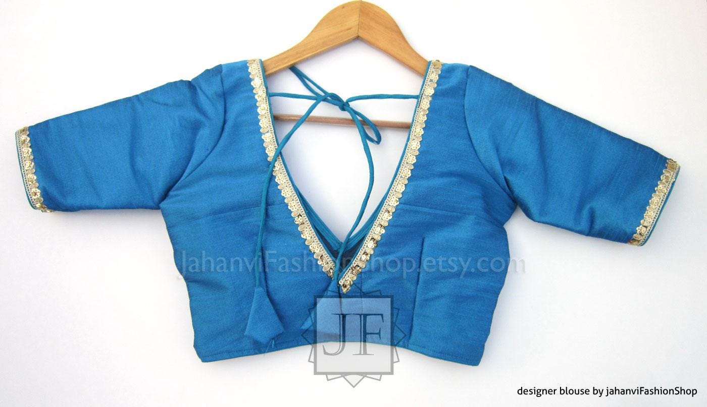 Blue V-neck saree blouse with gold lace trim, draped back tie, wide sleeves