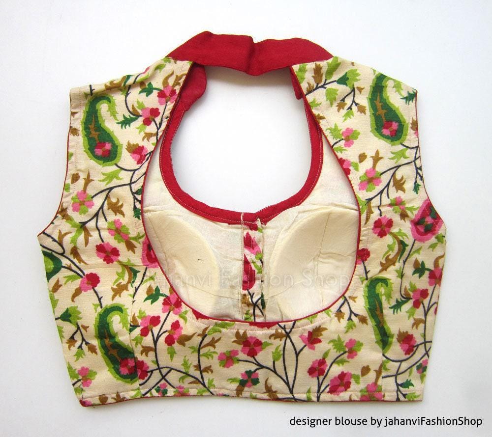 Printed sleeveless saree blouse with red neck trim, center tie and open bust panels