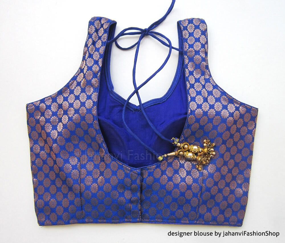 Blue brocade sleeveless saree blouse, open back with tie strings and hook closure detail