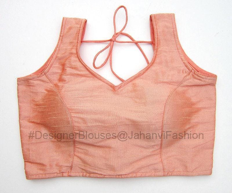 Peach sleeveless saree blouse with V-neck and crisscross ribbon back