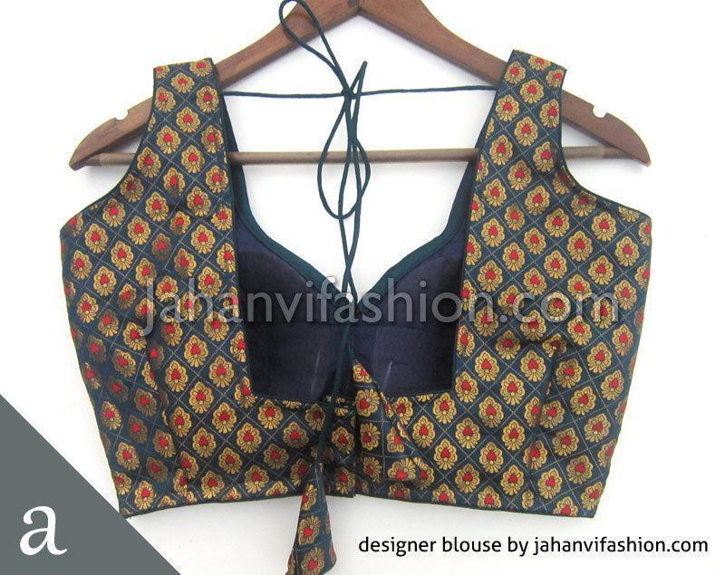 Sleeveless dark teal brocade blouse with sweetheart neckline and floral border, hanging on hanger