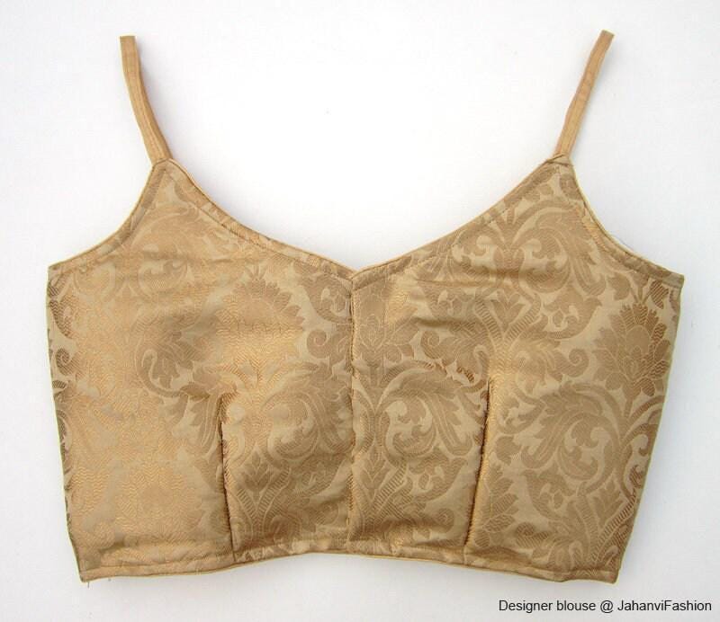 Front-view golden brocade crop blouse with spaghetti straps and curved neckline