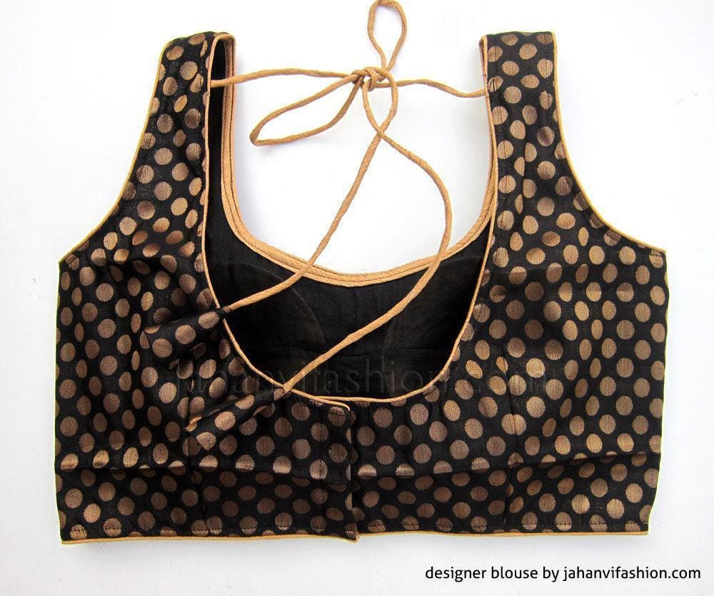 Black scoop-neck blouse with gold polka-dot print and lace-up neckline