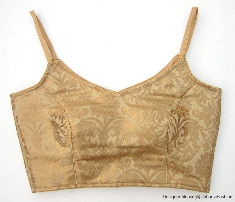 Golden spaghetti-strap saree blouse crop top with ornate brocade pattern and V-neck