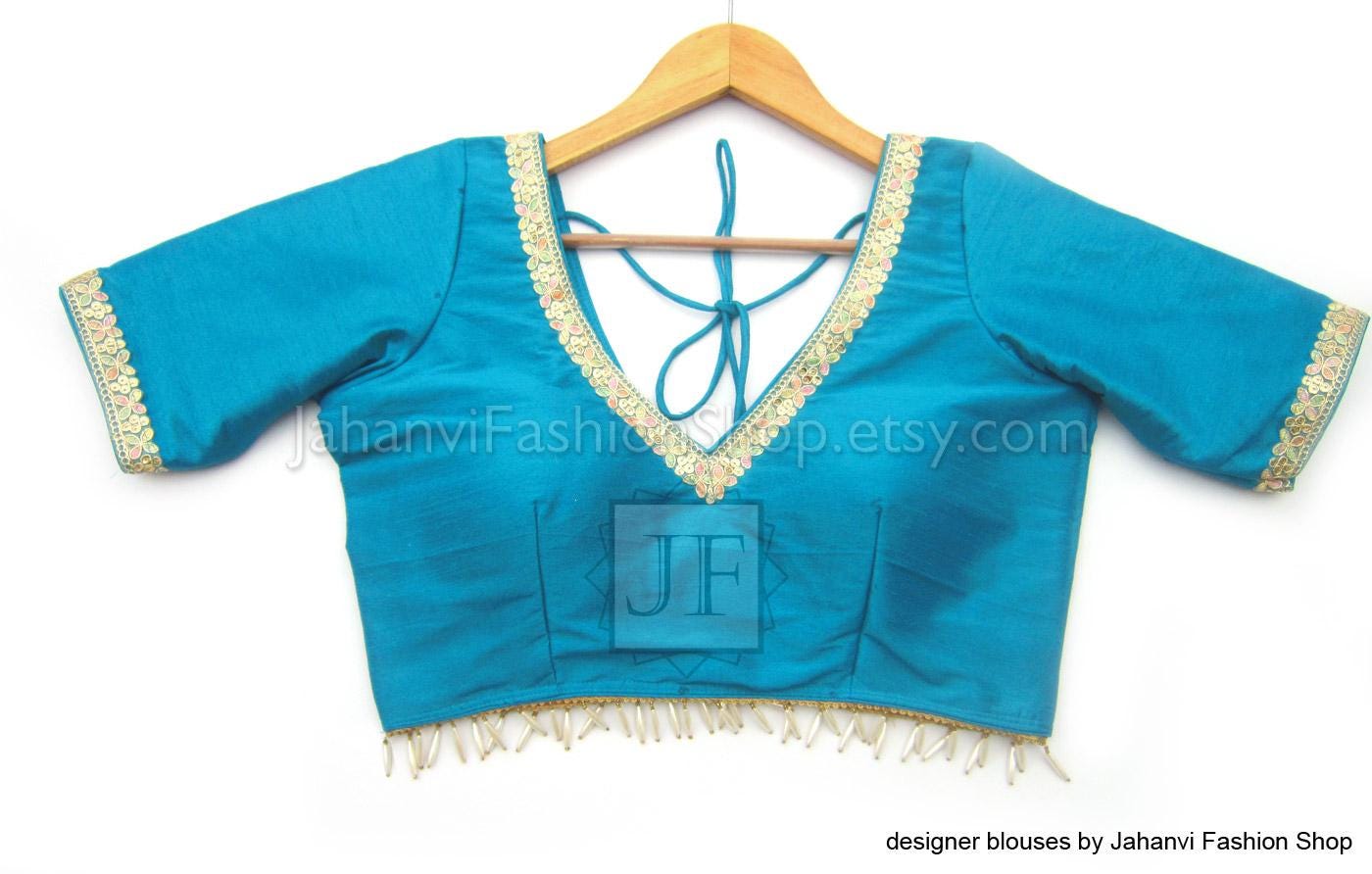 Teal saree blouse top, back view with V-neck opening and golden lace trim