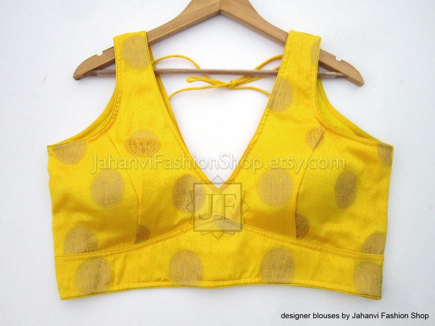 Yellow brocade sleeveless V-neck crop top with dot pattern and lace-up back ties