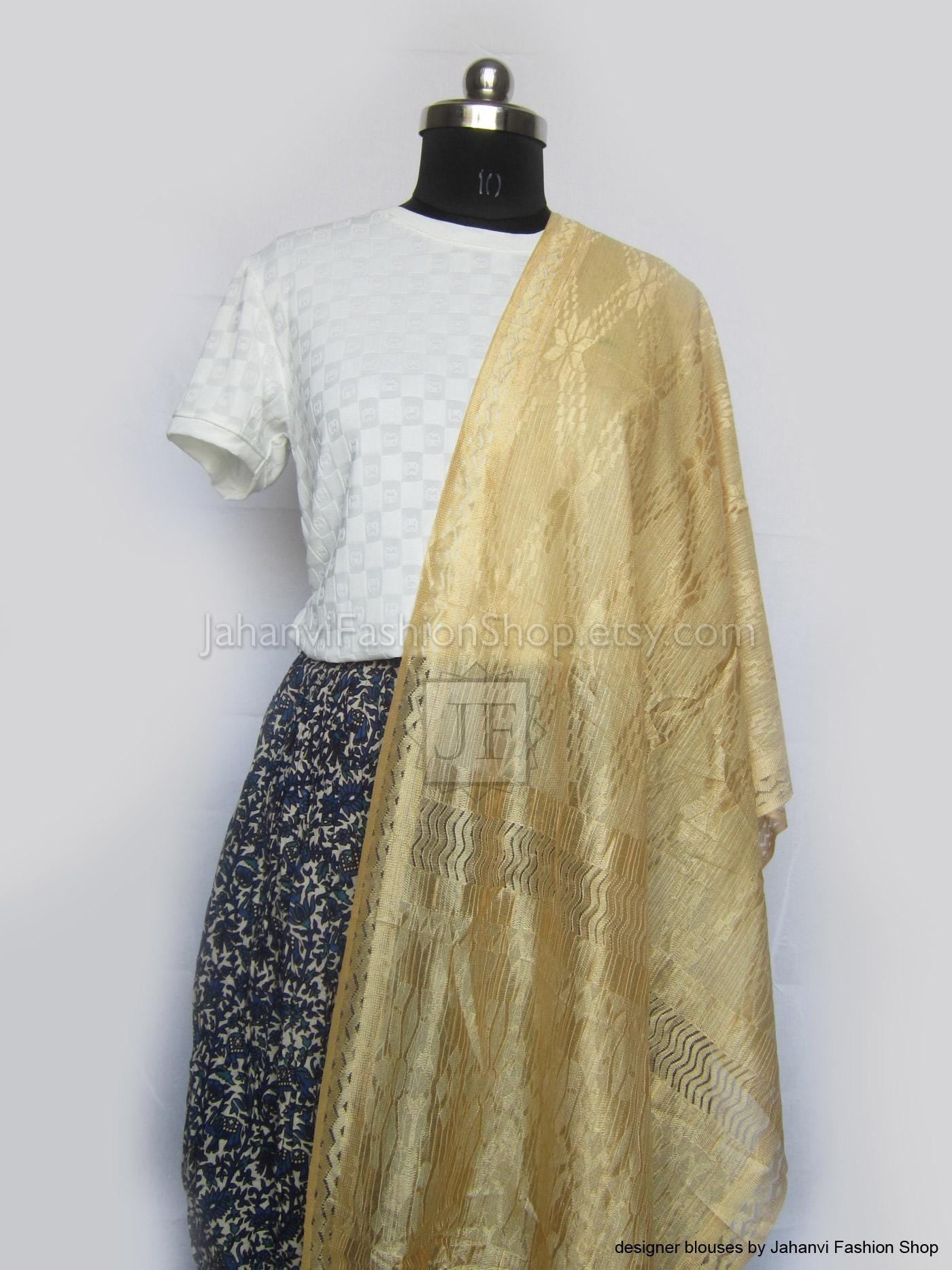 Golden and white dupatta scarf with gold border, draped over shoulder.