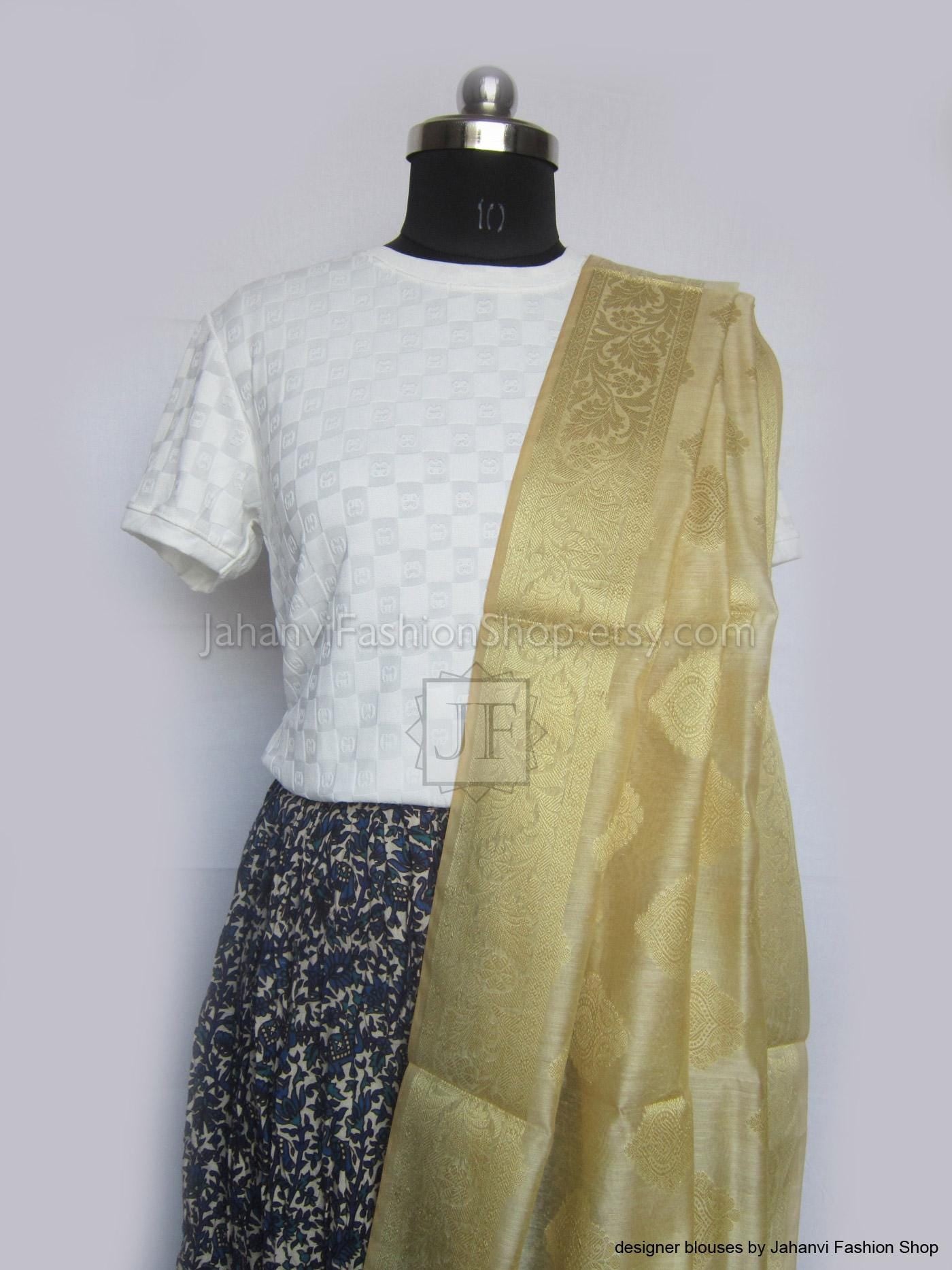 Light golden dupatta with shimmer and allover leaf motifs, laid across shoulder