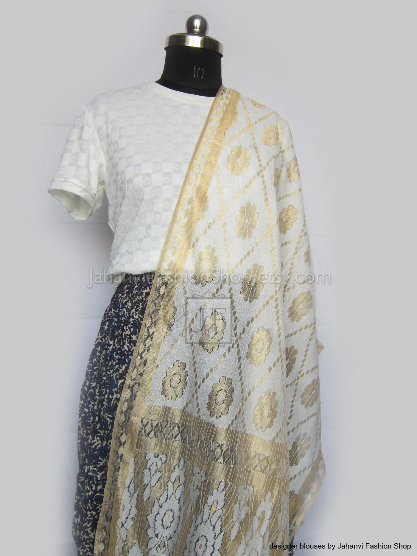 White dupatta scarf with gold woven trim and floral motifs, draped diagonally.