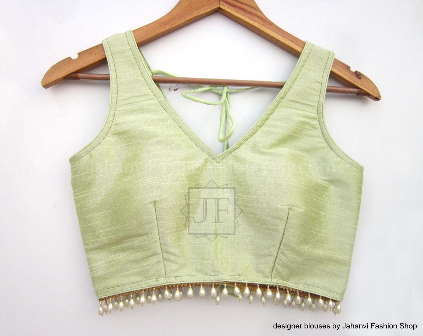 Lime green V-neck sleeveless saree blouse with pearl beaded trim at hem