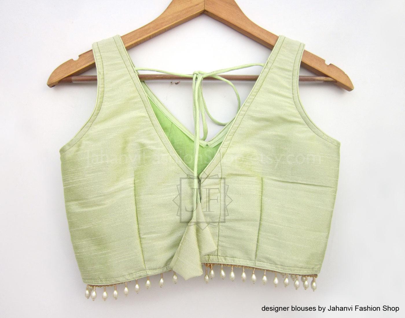 Lime green V-neck saree blouse with draped back tie and pearl beaded trim