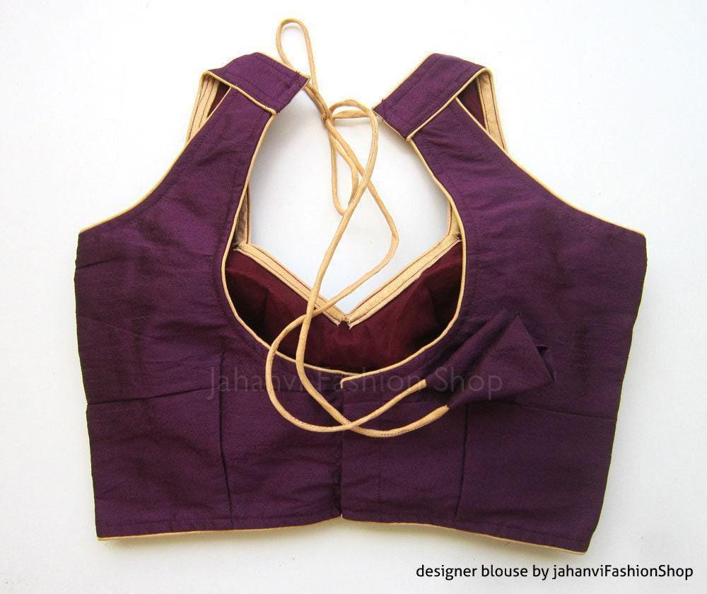 Wine halter saree blouse with deep V back and gold-edged border