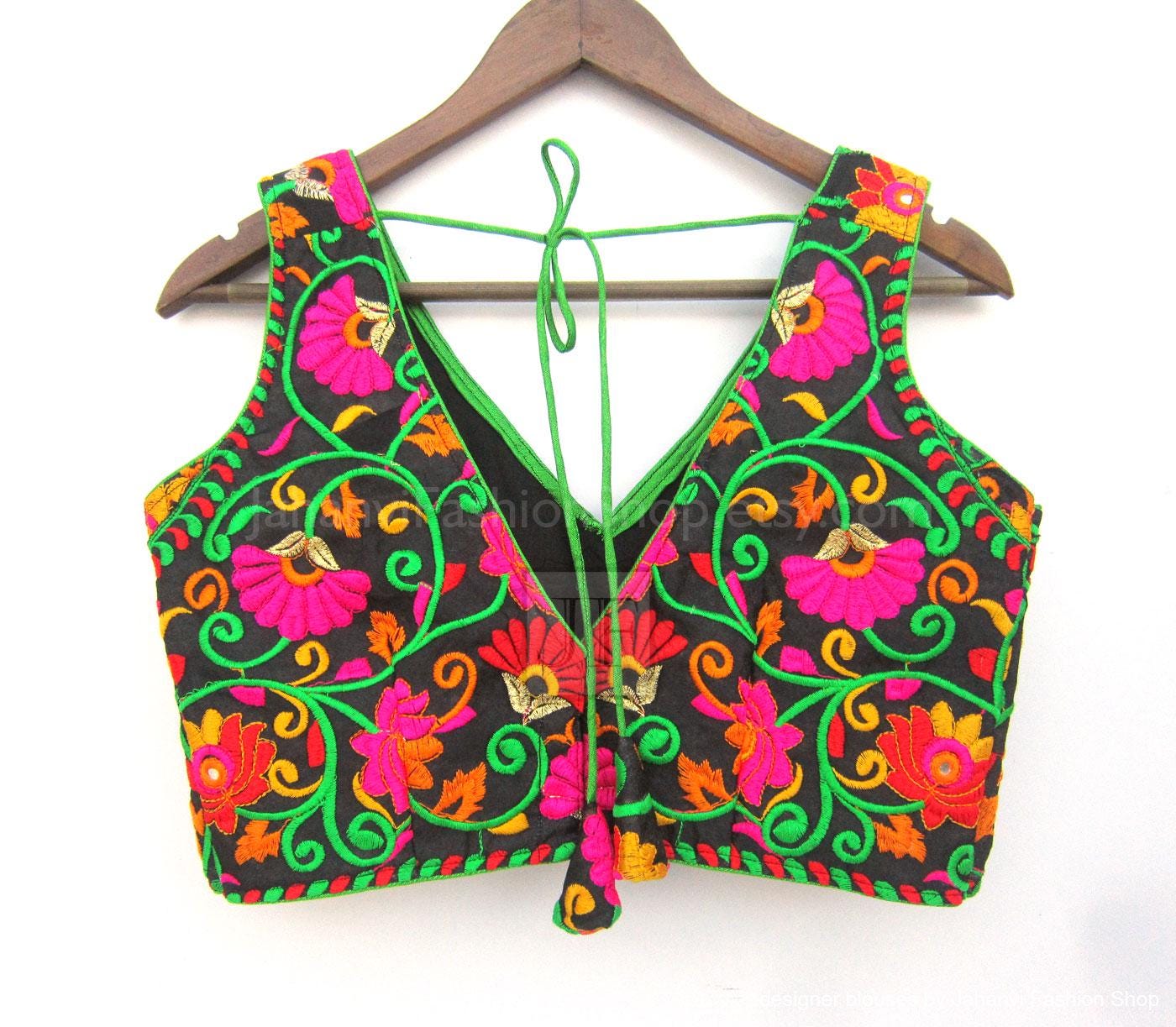 Embroidered V-neck saree blouse with colorful floral motifs, front laces and green edge
