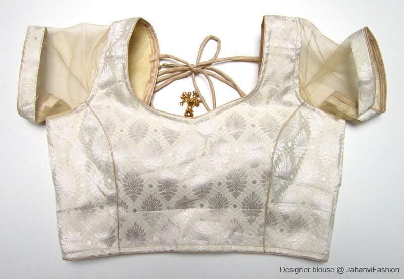 Brocade saree blouse with short net sleeves and tie-open back, cream-gold pattern