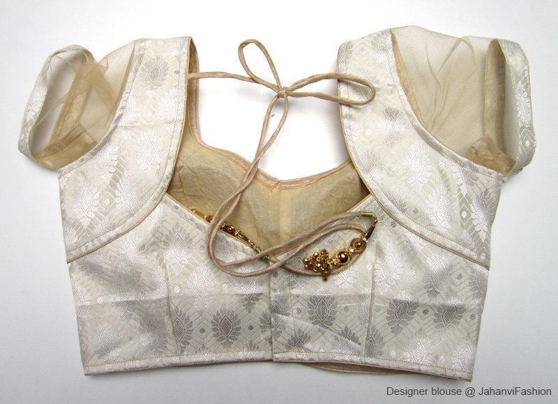 Brocade saree blouse with short net sleeves, tie-open back, and gold accent trim
