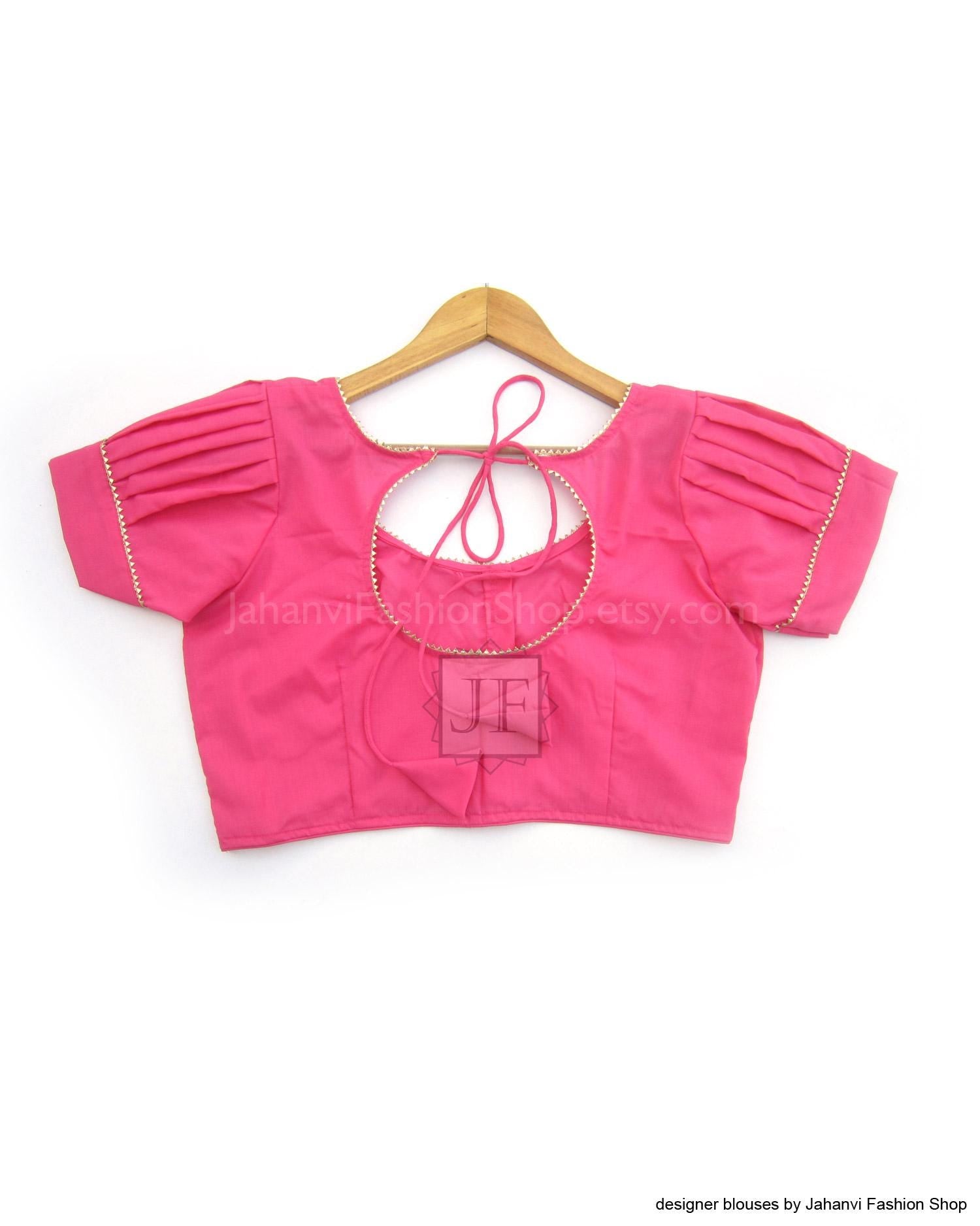 Pink puff-sleeve cotton saree blouse with open V-back and neck tie, golden trim