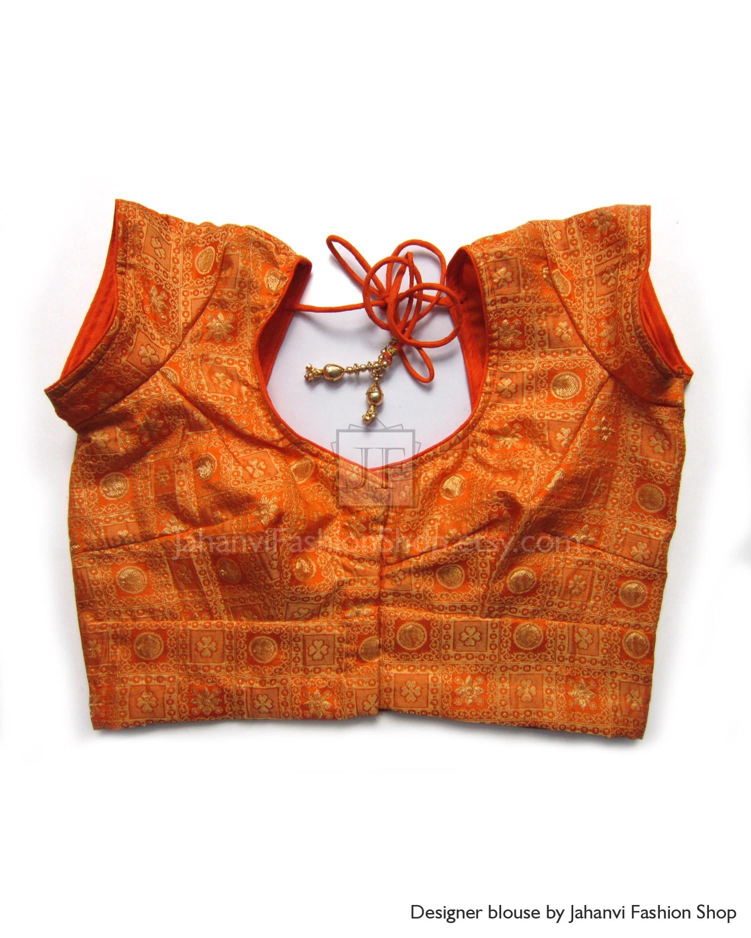 Orange brocade blouse with short sleeves, V-neck, and decorative tie-string with charms