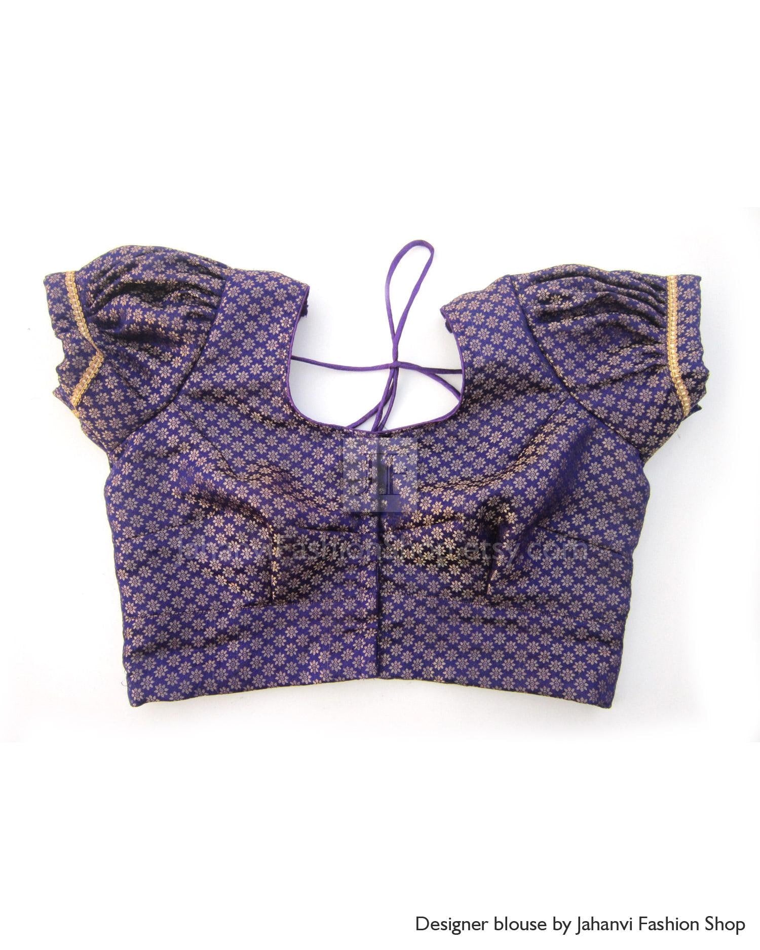 Dark blue printed crop blouse with puff sleeves, tie-neck lacing and gold trim
